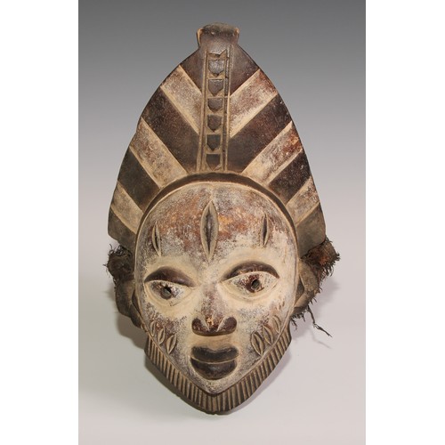 707 - Decorative Tribal Art and the Eclectic Interior - a Baule mask, lofty stylised coiffure, scarified f... 