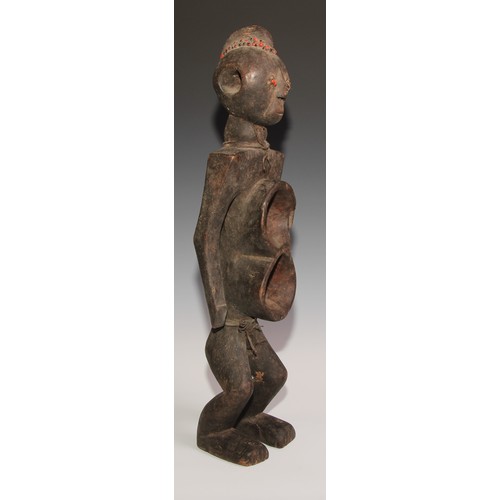 716 - Decorative Tribal Art and the Eclectic Interior- an African power or fetish figure, figure-of-eight ... 