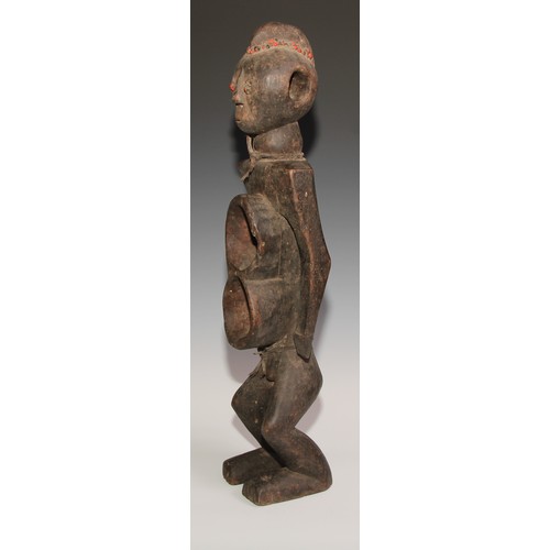 716 - Decorative Tribal Art and the Eclectic Interior- an African power or fetish figure, figure-of-eight ... 