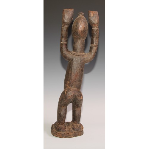 710 - Decorative Tribal Art and the Eclectic Interior - a Dogon Tellem altar figure, typically posed with ... 