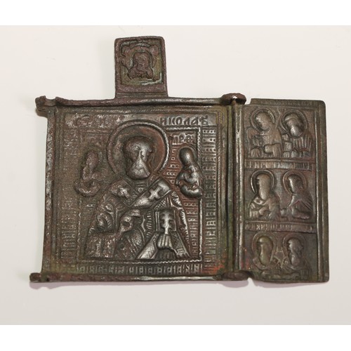 444 - A Russian Orthodox brass triptych icon, in relief with scenes from the life of St Nicholas of Mozhai... 