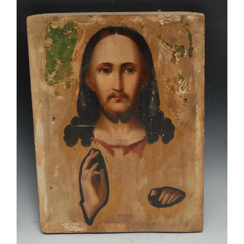 541 - An Eastern Orthodox icon, painted in polychrome with Christ, his handing making the gesture of Chi R... 