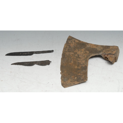 840 - Antiquities - a Viking iron axehead, 26cm long, c.12th century; two Medieval knife blades, 17.5cm an... 