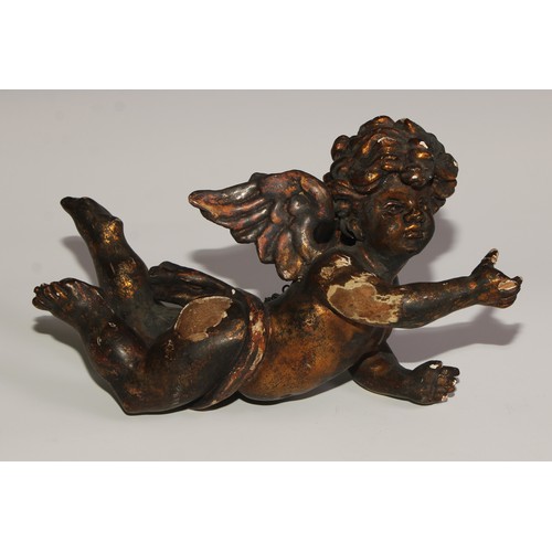 110 - A 19th century Italian carved limewood putto, 28cm wide