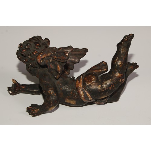 110 - A 19th century Italian carved limewood putto, 28cm wide