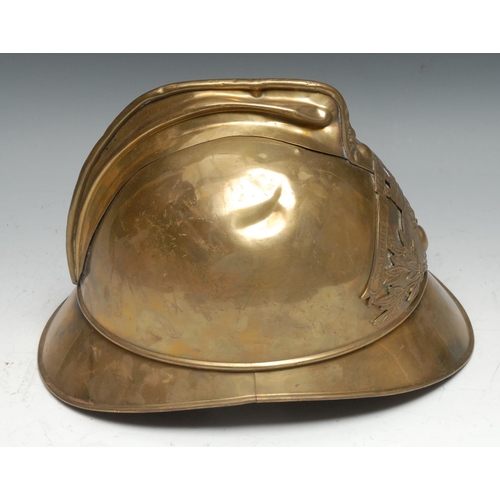 320 - A French 1895 pattern brass fire brigade helmet, embossed and applied with flaming grenade device an... 