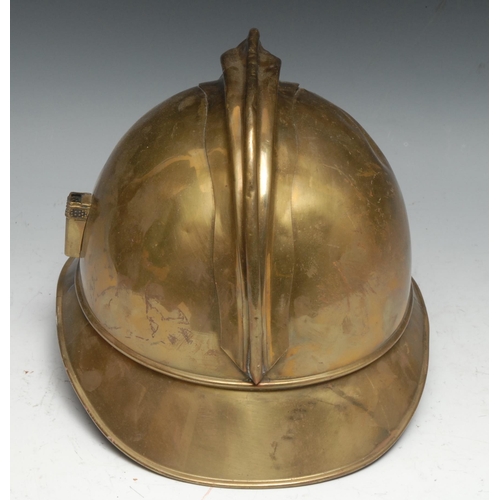 320 - A French 1895 pattern brass fire brigade helmet, embossed and applied with flaming grenade device an... 