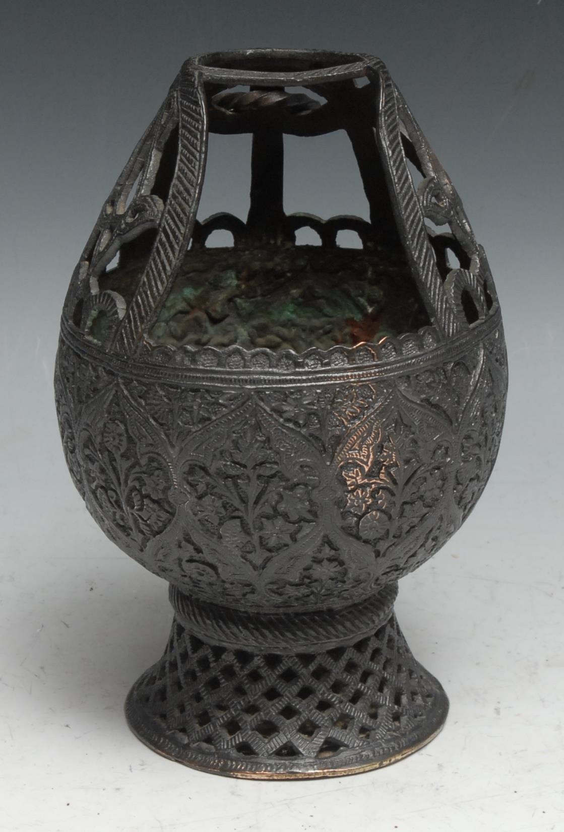 An Indian dark patinated copper alloy lamp or censer, chased in the