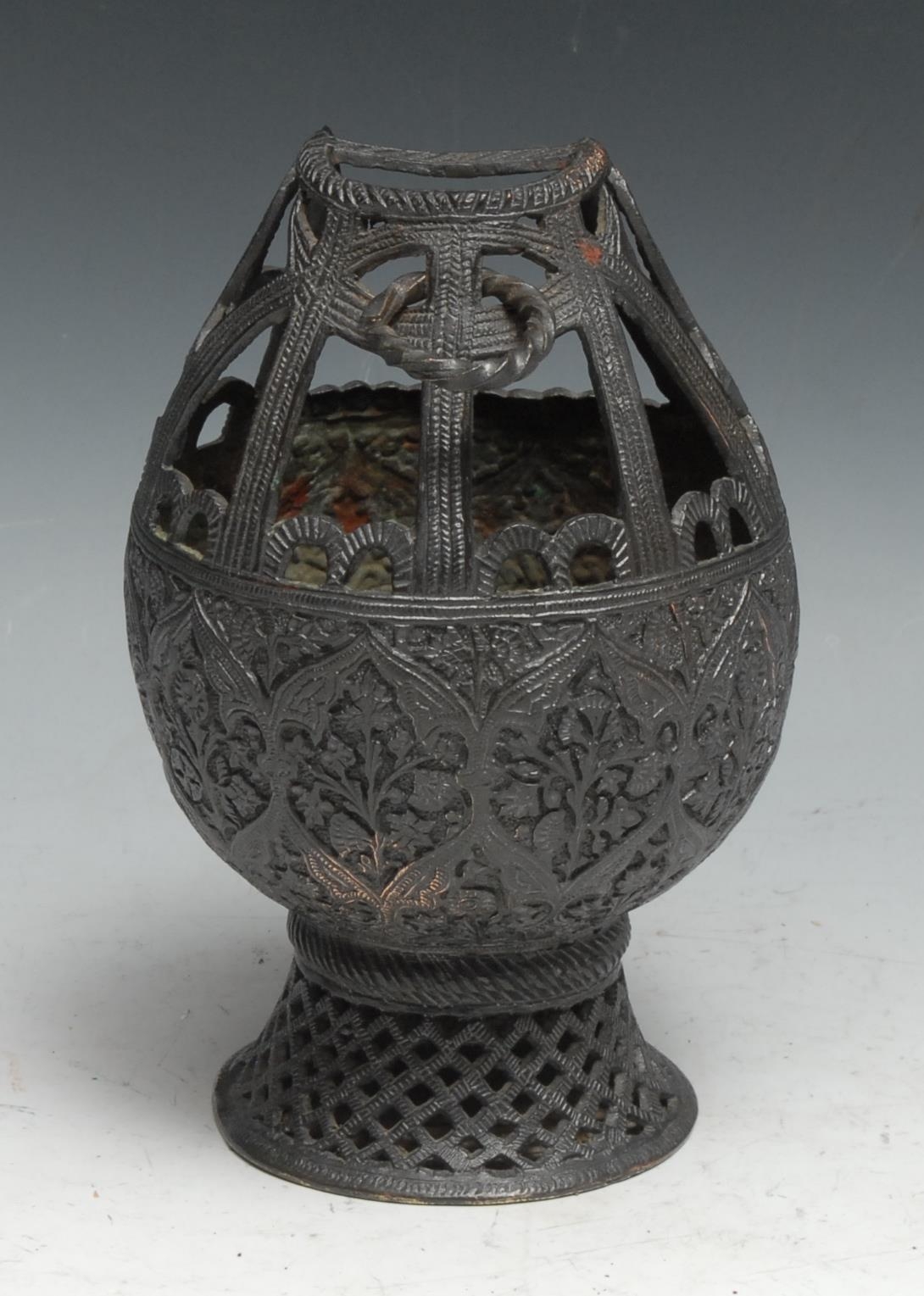 An Indian dark patinated copper alloy lamp or censer, chased in the