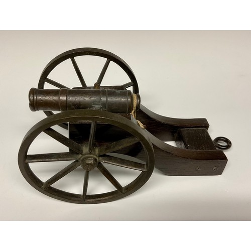 282 - A bronze library model signalling cannon, 13cm barrel with live touch-hole, the oak carriage with br... 