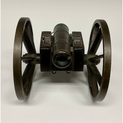 282 - A bronze library model signalling cannon, 13cm barrel with live touch-hole, the oak carriage with br... 