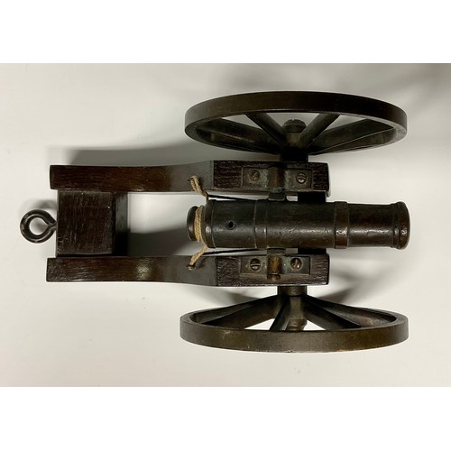 282 - A bronze library model signalling cannon, 13cm barrel with live touch-hole, the oak carriage with br... 