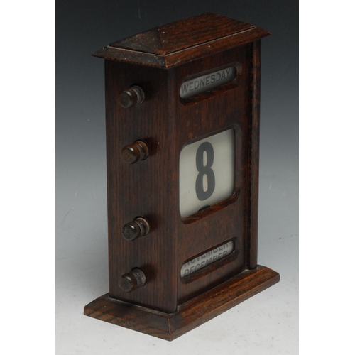 536 - An early 20th century oak perpetual calendar, sarcophagus cresting above glazed apertures for day, d... 