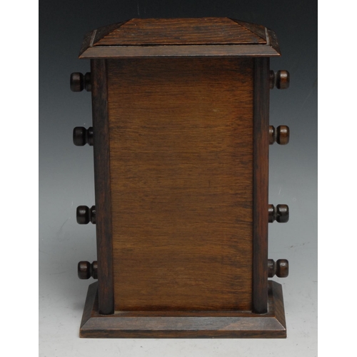 536 - An early 20th century oak perpetual calendar, sarcophagus cresting above glazed apertures for day, d... 