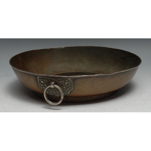 266 - A 19th century Tibetan silver mounted copper bowl, the loose ring handle with lotus shaped boss chas... 