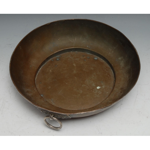 266 - A 19th century Tibetan silver mounted copper bowl, the loose ring handle with lotus shaped boss chas... 