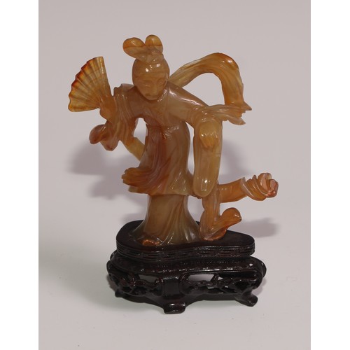 63 - A Chinese agate figure, carved as Guanyin, hardwood base, 11.5cm high overall; a snuff bottle; a ros... 