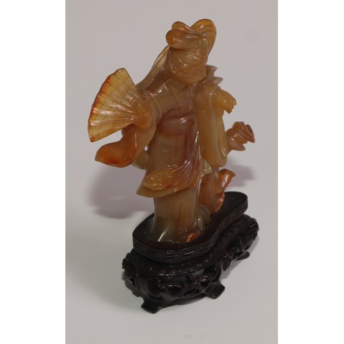 63 - A Chinese agate figure, carved as Guanyin, hardwood base, 11.5cm high overall; a snuff bottle; a ros... 