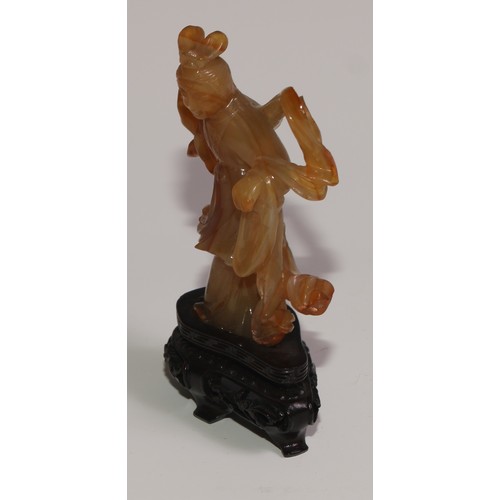 63 - A Chinese agate figure, carved as Guanyin, hardwood base, 11.5cm high overall; a snuff bottle; a ros... 