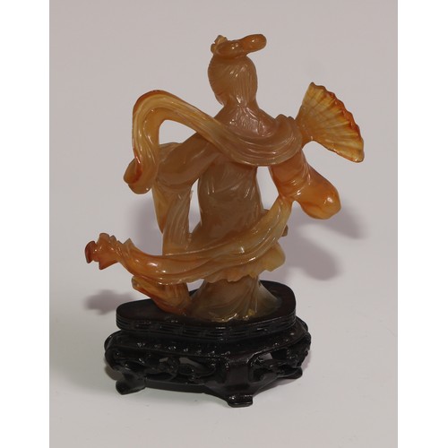 63 - A Chinese agate figure, carved as Guanyin, hardwood base, 11.5cm high overall; a snuff bottle; a ros... 