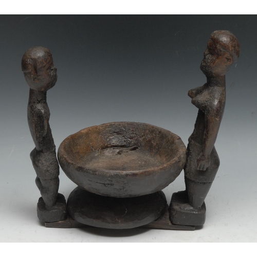 729 - Tribal Art - an African offering bowl, flanked by a pair of opposing figures, 23.5cm wide,  probably... 