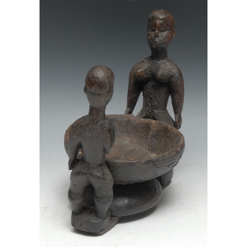 729 - Tribal Art - an African offering bowl, flanked by a pair of opposing figures, 23.5cm wide,  probably... 