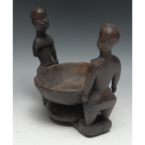 729 - Tribal Art - an African offering bowl, flanked by a pair of opposing figures, 23.5cm wide,  probably... 