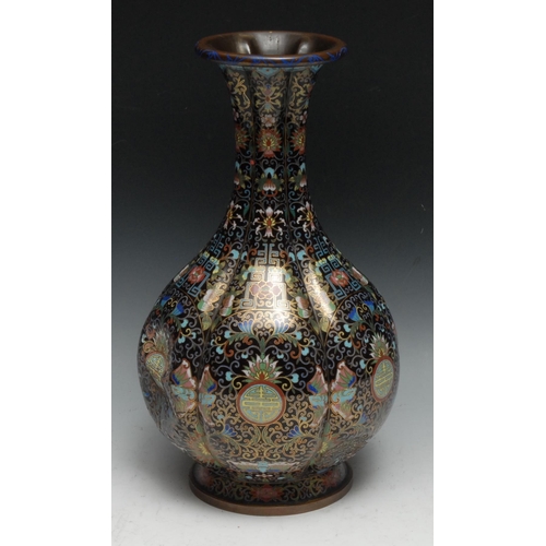 286 - A Chinese cloisonne enamel fluted ovoid vase, decorated in polychrome with shou, butterflies, flower... 