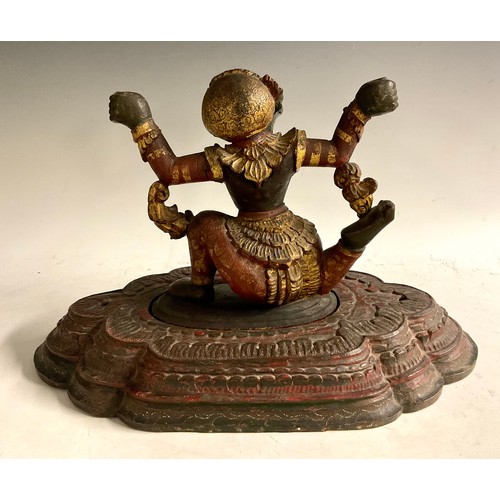 466 - A South Asian polychrome carving, of a demon, stepped lotus base, 46cm wide, 19th/early 20th century