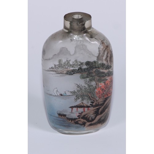 292 - A Chinese inside painted glass snuff bottle, decorated with figures in a monumental landscape, 7cm h... 