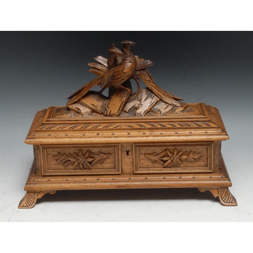 59 - A Black Forest rectangular box, hinged cover surmounted by a pair of pheasants, the interior lined i... 