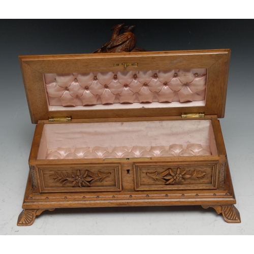 59 - A Black Forest rectangular box, hinged cover surmounted by a pair of pheasants, the interior lined i... 