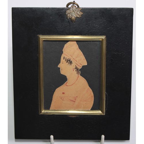 142 - English School (19th century), a cut-paper portrait miniature, of a lady wearing a coral necklace, b... 