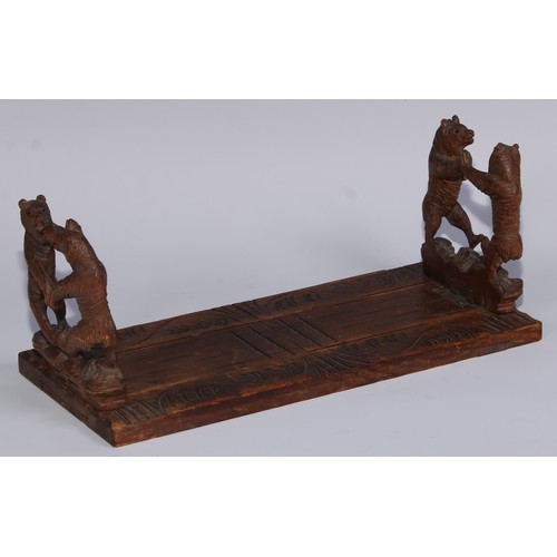 57 - A Black Forest novelty book slide, each folding end support carved with dancing bears, 31cm wide, ea... 