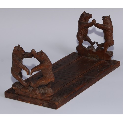 57 - A Black Forest novelty book slide, each folding end support carved with dancing bears, 31cm wide, ea... 