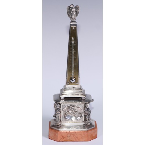 538 - An early 20th century silvered obelisk desk thermometer, eagle finial, the friece with bas relief an... 