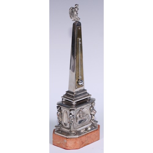 538 - An early 20th century silvered obelisk desk thermometer, eagle finial, the friece with bas relief an... 