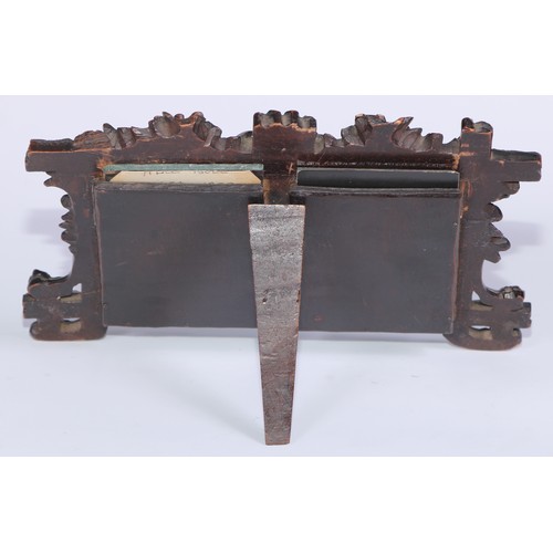 56 - A Black Forest easel double photograph frame, carved with fruiting oak, 20.5cm wide, c.1900