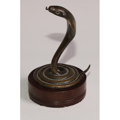 283 - A bronze novelty pocket watch stand, as a coiled Indian cobra, hardwood base, 15cm high