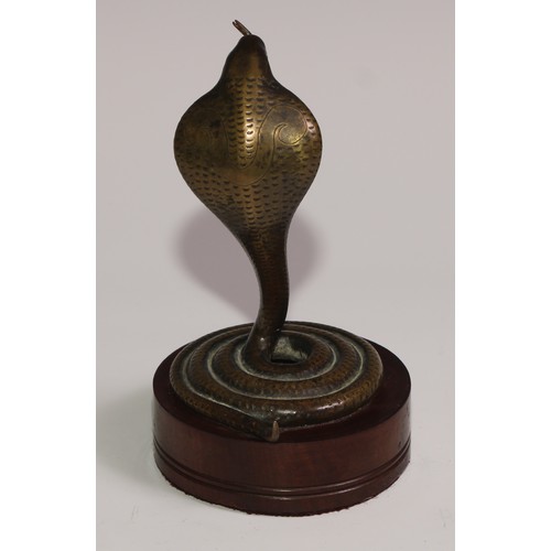 283 - A bronze novelty pocket watch stand, as a coiled Indian cobra, hardwood base, 15cm high