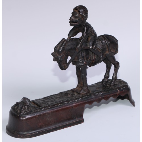 6 - A 19th century American cast iron novelty mechanical bank money box, as a jockey thrown  from his mo... 