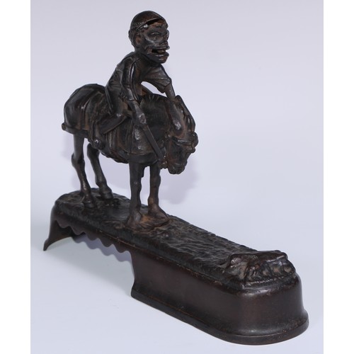 6 - A 19th century American cast iron novelty mechanical bank money box, as a jockey thrown  from his mo... 