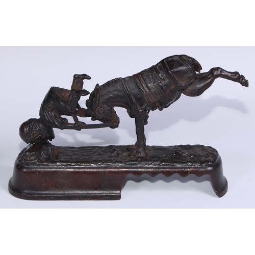 6 - A 19th century American cast iron novelty mechanical bank money box, as a jockey thrown  from his mo... 