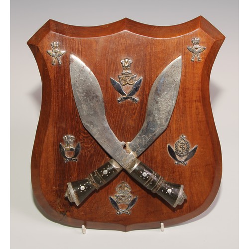 744 - Military Interest - The Ghurka Regiment - a presentation shield, applied with crossed kukri and insi... 