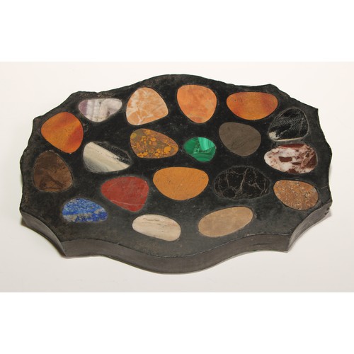 438 - A pietra dura shaped serpentine desk weight, inlaid with pebble shaped reserves of malachite, laps l... 