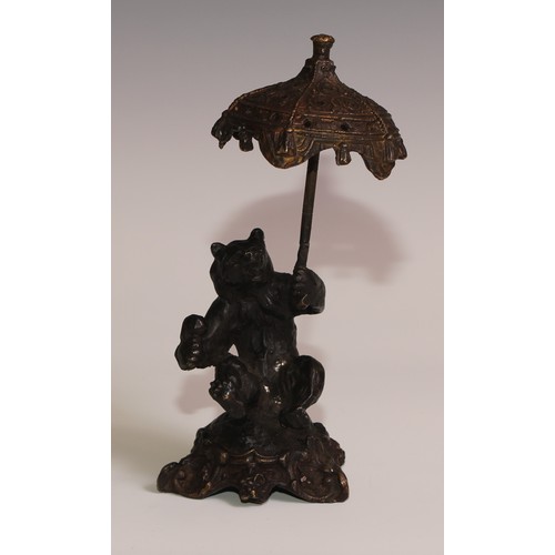 281 - A bronze desk novelty, cast after Fratin as a bear, holding a parasol, 21cm high