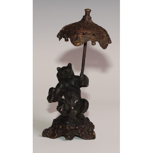 281 - A bronze desk novelty, cast after Fratin as a bear, holding a parasol, 21cm high