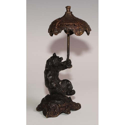 281 - A bronze desk novelty, cast after Fratin as a bear, holding a parasol, 21cm high