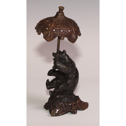 281 - A bronze desk novelty, cast after Fratin as a bear, holding a parasol, 21cm high