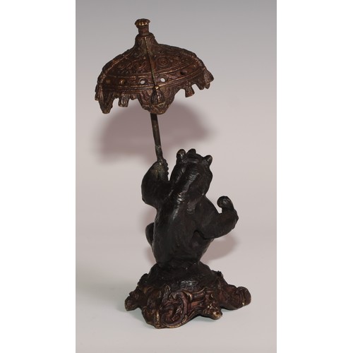 281 - A bronze desk novelty, cast after Fratin as a bear, holding a parasol, 21cm high